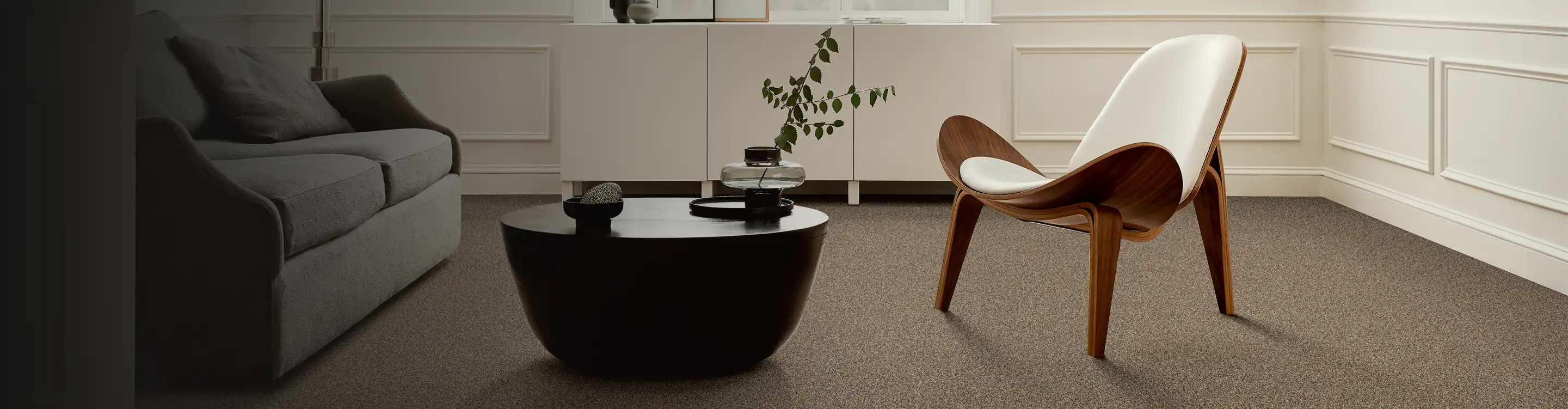 brown carpet in a living room with a modern, wooden accent chair