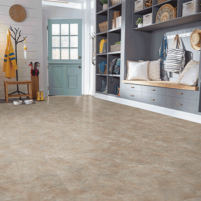 stone look luxury vinyl tile flooring in entryway with shoe storage