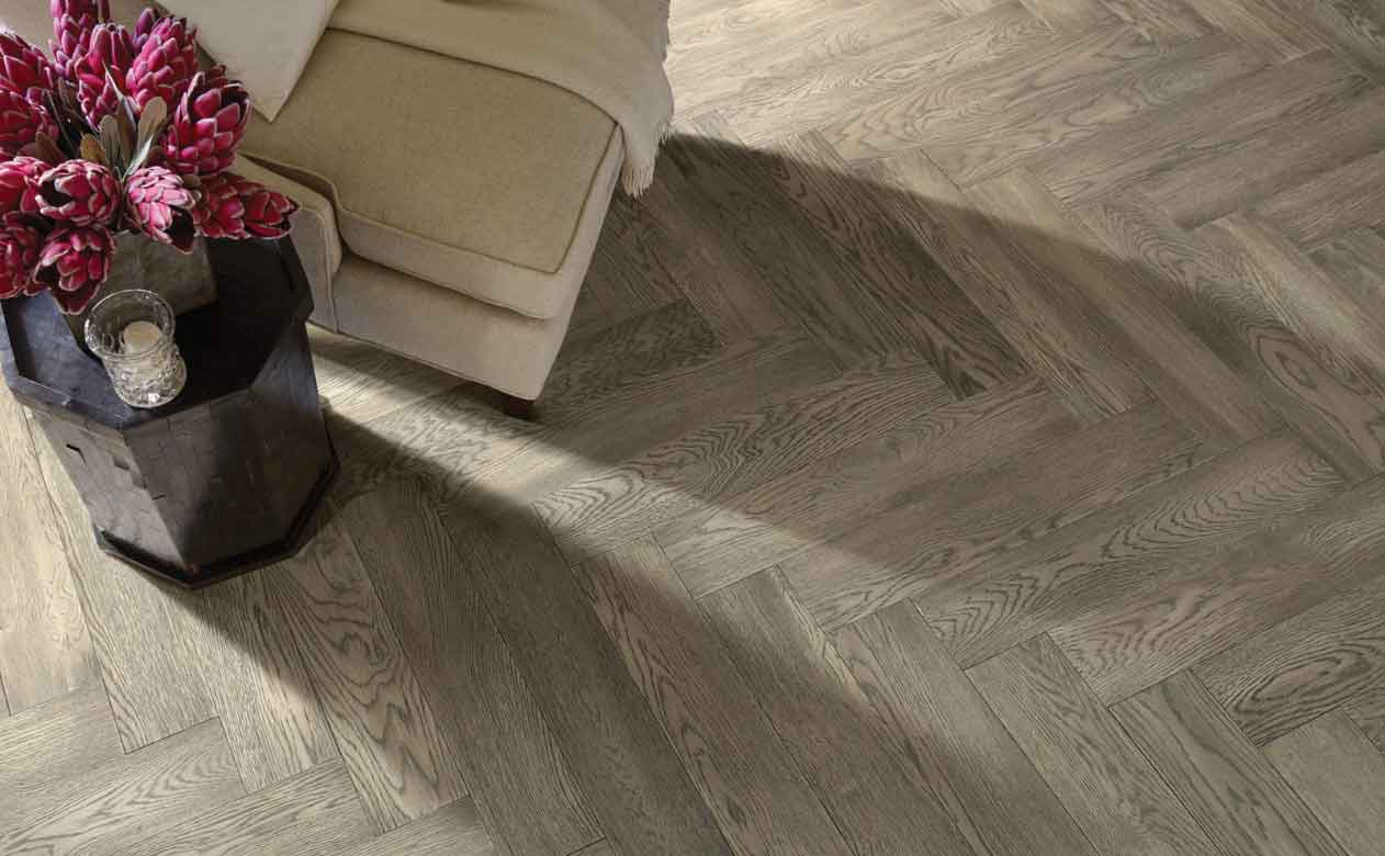 Herringbone patterned Hardwood Flooring in Great Falls, MT, Living Room with Chair and Table