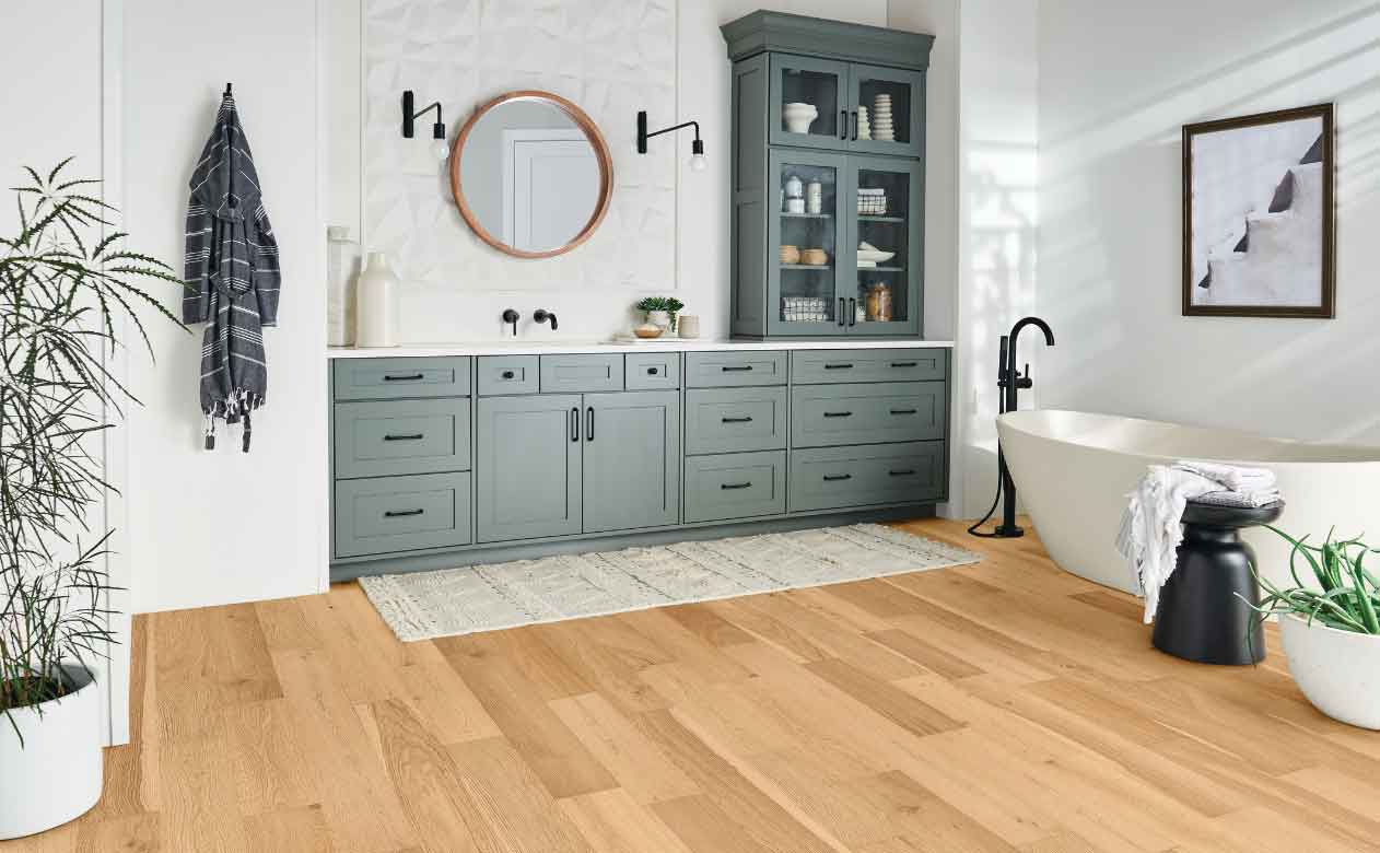 Hardwood Flooring in a Montana Bathroom with Tub, Sink, Mirror, and Cabinets